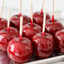 9 Red candies apples sitting on a tray